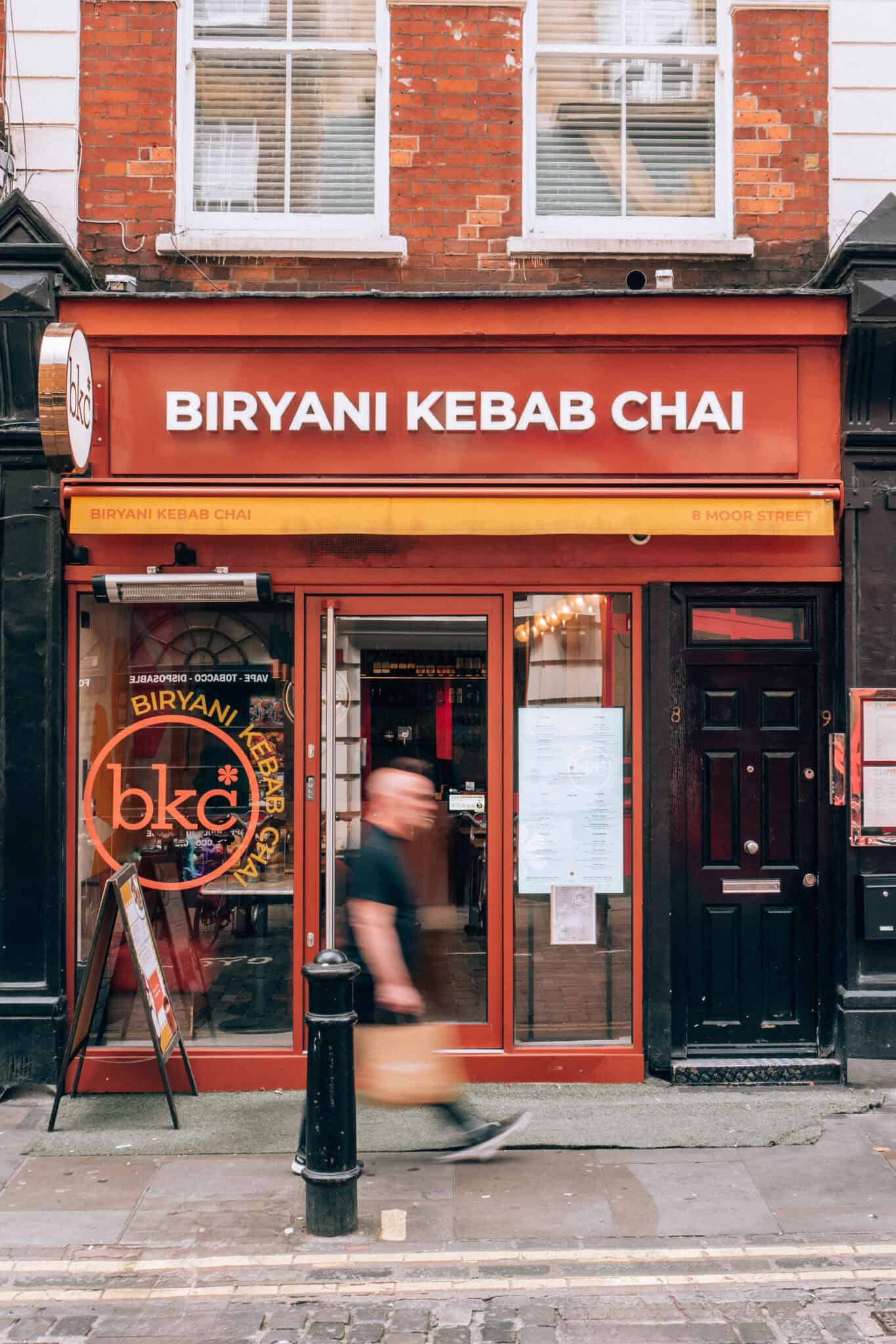 Biryani Kebab Chai restaurant exterior with signage on a busy street.